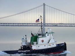 four rescued after tug sinks off big