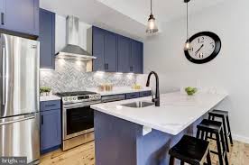 To keep a dark gray kitchen from feeling heavy or dark, use a section of open shelving to visually break up the space. The Five Best Looking Open Houses This Weekend 7 6 7 7 Kitchen Design White Kitchen Design Dark Brown Kitchen Cabinets