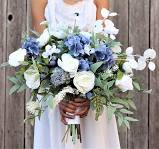 Young bride holds oversized wedding bouquet with blue thistle flowers, jana roses, eucalyptus leaves close up. 161 29