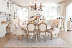 Brown dining room with dark wood dining table surrounded with floral cushioned chairs over a patterned rug. The Right Rug Size For Your Dining Room Ruggable Blog