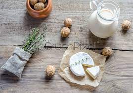 Camembert With Pitcher Of Milk And Whole Nuts Stock Photo Crushpixel