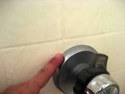 Use a thin, stiff wire like a scrap electrical wire or coat hanger to avoid enlarging the hole at the tip. How To Caulk Shower And Bathtub Trim