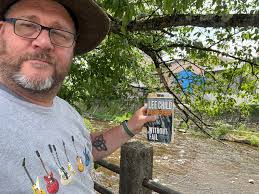 Reading my book near the little river. I'm enjoying this. So beautiful.  Nice smells and sounds. Very relaxing. (Takayama, Japan) Update: I finished  my book! :)