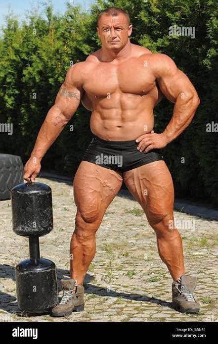 Mariusz Pudzianowski, a renowned Polish strongman and five-time winner of the  World's Strongest Man competition, is depicted in this image from June 1st.  He is considered one of the greatest athletes in