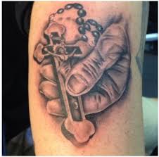A conventional rosary tattoo hanging around the neck to stay blessed. Rosary Cross Jesus Hand Tattoo Design Entertainmentmesh