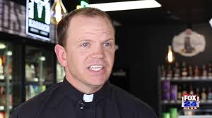 PRIEST BLESSES NEW LIQUOR STORE