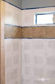 After the tile paint has dried over night, re tape the decorative area, this time overlapping the paint onto the white painted tile. How To Paint Shower Tile Remington Avenue