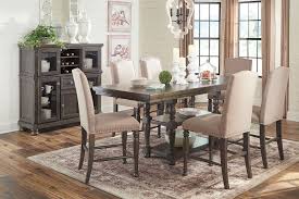 Modern counter height dining set featuring a beautiful rounded table and six high back chairs. Audberry Counter Height Dining Room Set By Signature Design By Ashley Furniturepick