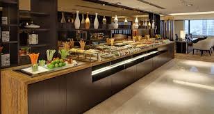 A buffet is a system of serving meals in which food is placed in a public area where the diners serve themselves. Hilton Petaling Jaya Hotel Buffet Buffet Table Decor Fine Dining Restaurant