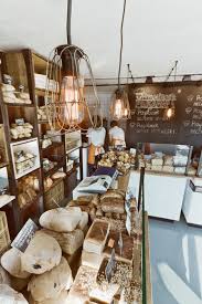 Wire Encased Lights Are Suspended Above Oak Topped Counters At This Bakery In Poland By Designer Maciej Kurkowski Bakery Interior Bakery Design Bakery