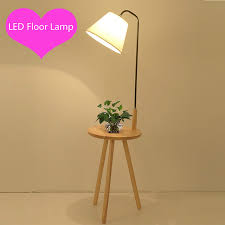 It's with the top shelf forming a charging station. Artpad Nordic Tripod Wooden Floor Lamp With Wood Shelf Fabric Lampshade E27 Modern Led Standing Floor Lamps For Living Room Floor Lamps Aliexpress