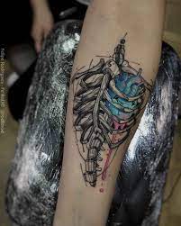The rib cage is that part of the body that's a bit hidden and ideal for some cool rib cage tattoo designs that you by love kimberly. Rib Cage Heart Tattoo On Arm Armtattoosdesigns Tattoos Ribcage Tattoo Skeleton Tattoos