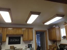 The mystery is solved and you won't break the acrylic cover! Replace Ugly Fluorescent Ceiling Fixtures In Kitchen