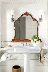 Give a bathroom an old world feel with beadboard, an assortment of curios, including brass picture frames, and vintage light fixtures. 10 Spots To Sneak In A Little More Shelf Storage Bathroom Decor Modern Farmhouse Bathroom Beautiful Bathrooms