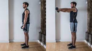 Stand up tall with your shoulder blades pulled together, holding one dumbbell in each hand. How To Master The Front Raise Coach
