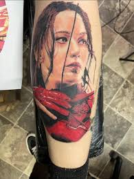 Hunger games fan shares katniss tattoo