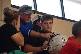 Dog Tag 2024. Varsity football members and their families met tonight to  place numbers and decals