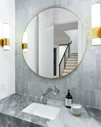 The modern, staggered brass chandelier in this example by interior designer lindye galloway is the perfect edgy touch for an elegant bathroom. Small Led Sconce Bathroom Mirror Lights Bathroom Mirror Round Mirror Bathroom