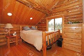 Log interior room for a teenager from the timber in a marine. Bedroom In Rustic Mountain Log Cabin With Large Scale Furniture Stock Photo Picture And Royalty Free Image Image 12312284