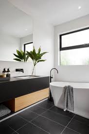 Black faucets and showerheads add a graphic pop against white subways or dramatic carrara or statuario slabs are to die for when paired with matte black. Modern Black And White Bathroom With Black Tile Matte Black Plumbing Fixtures Black Bathroom White Bathroom Bathroom Inspiration