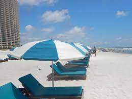 rent an umbrella and beach chair at turquoise place and someone will adjust your umbrella all day to the changing orange beach gulf shores vacation gulf shores