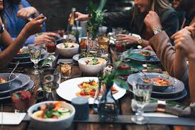 A dinner party is a formal social gathering at which people eat dinner together, usually in the host's own home. Friends At Outdoor Dinner Party By Lumina Eat Food