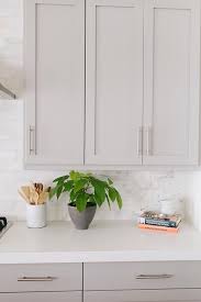 Whether you prefer a modern or traditional design, and no matter how big or small your kitchen is, we have a huge selection of cabinets that are not only beautiful but also work smartly, so you can cook more efficient. Grey Kitchen Cabinets With Caesarstone Organic White Counters Transitional Kitchen Benjamin Moore Mindful Gray