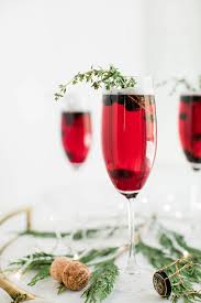 Two glasses of blue cocktail on table. Blueberry Sparkler Champagne Cocktails The Sweetest Occasion
