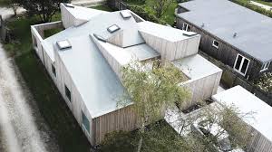 The lower end of rafter is attached. Sigurd Larsen S Roof House Features Intersecting Slanted Roofs