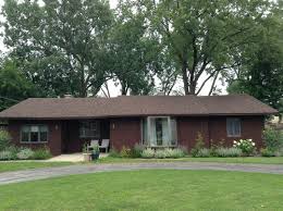 Large blue house with white trim, and well kept lawn, along with two garage spaces. Brown Brown More Brown Need Help On Exterior Siding Color