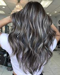 Going Gray Gray Blending A Technique That Weaves Gray Highlights And Lowlights Into Your Hair Is In 2021 Gray Hair Highlights Blending Gray Hair Brunette Hair Color