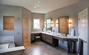 Modern master bathroom in black and white boasting a black oval bathtub on dark gray grid floor tiles surrounded by marble walls and white vanities. Contemporary Master Suite Addition In Sun Prairie Wi Sweeney Design Build