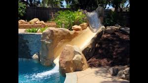 See pictures of rock waterfall slides on swimming pools. Awesome 25 Fake Rock Pool Slide Done Youtube