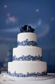 Blue watercolor brushstrokes bring the only pop of color to this otherwise white tiered cake. Wedding Cakes Pictures Blue And White Wedding Cakes Wedding Cakes Blue Wedding Cake Pictures White Wedding Cakes