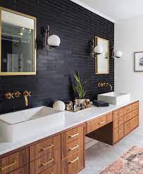 This master bathroom features a double sink vanity with dark brown wooden cabinets and neutral granite countertops. 9 Ideas For The Space Between Double Sinks In The Bathroom