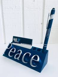 This stainless steel business card holder comes in a gunmetal color in brushed finish. Peace Business Card Pen Holders Rise Up Industries