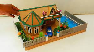 This is an inexpensive project that offers a chance to reuse cardboard from boxes or packaging. Cardboard House With Swimming Pool And Garden Diy Cardboard House Cardboard Crafts Miniature Houses Cardboard