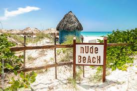 Nude Beach Sign. Sign indicating nude beach with tropical sandy beach.  Stock Photo | Adobe Stock