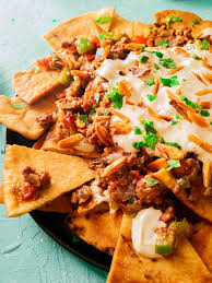These loaded nachos are piled high with chips, beef, beans, cheese, pico de gallo, and avocado. Beef Eggplant Middle Eastern Nachos Fusion Recipes
