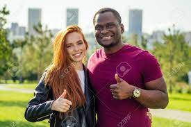 Close Up Of Interracial Couple Holding White Rose In Spring Autumn Park  Stock Photo, Picture And Royalty Free Image. Image 144574311.