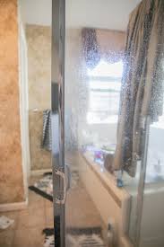 Using the same tile pattern on the bathtub surround and on the shower. How To Remove Hard Water Stains From Glass Shower Doors The Forked Spoon