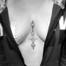 The spirals represent the twists and turns in life, while the straight line is enlightenment. Cleavage Tattoo