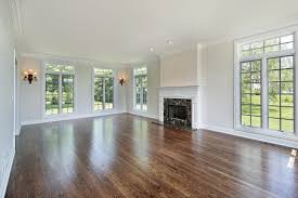 .grey splashback, stone slab splashback, stainless steel appliances, dark hardwood flooring, an island, brown floors and grey worktops. Different Types Of Polyurethane Finishes