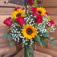Most flowers can be paired with sunflowers depending on the colors and style of the arrangement. Sunflowers And Roses By Gateway Florist