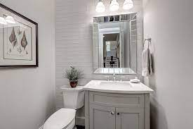 Glossy gray tile in a chevron pattern provides a unique accent wall. Refined And Refreshing Trendy Powder Rooms In Gray And Turquoise