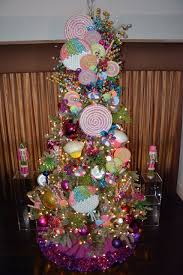 Decorating the christmas tree is one of the best holiday traditions there is! Candyland Christmas Tree Decor With Colorful Lollipop Ornaments Whimsical Christmas Tree Decorating Themes Creative Christmas Trees Christmas Tree Decorations