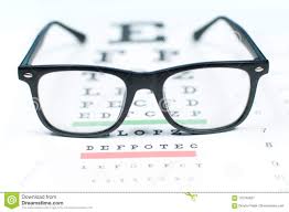 eye vision test chart seen through eye glasses stock image