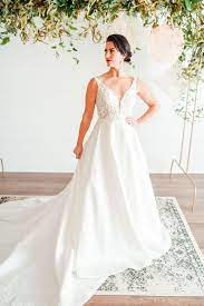 The Wedding Studio In Carmel Indiana At The Clay Terrace Shopping Center Offers A Unique Var Asymmetrical Wedding Dress Affordable Bridal Gowns Wedding Dresses