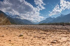 Dry cracked earth ground with stones in mountain land at blue sky ⬇ Stock Photo, Image by © a4ndreas #106251416