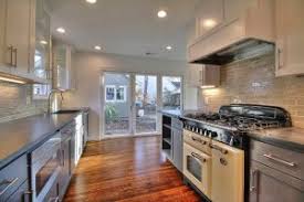 Typically cabinets come before flooring in most cases, given standard flooring heights, you will install the cabinets before the floor covering. Floor And Cabinet Installations In Your Kitchen Remodel